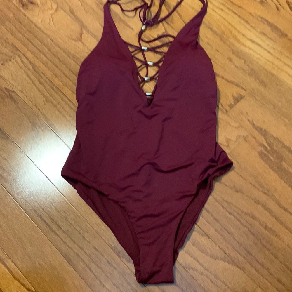 Burgundy Size M-L one piece swimsuit with shoe lace detail and gold bling